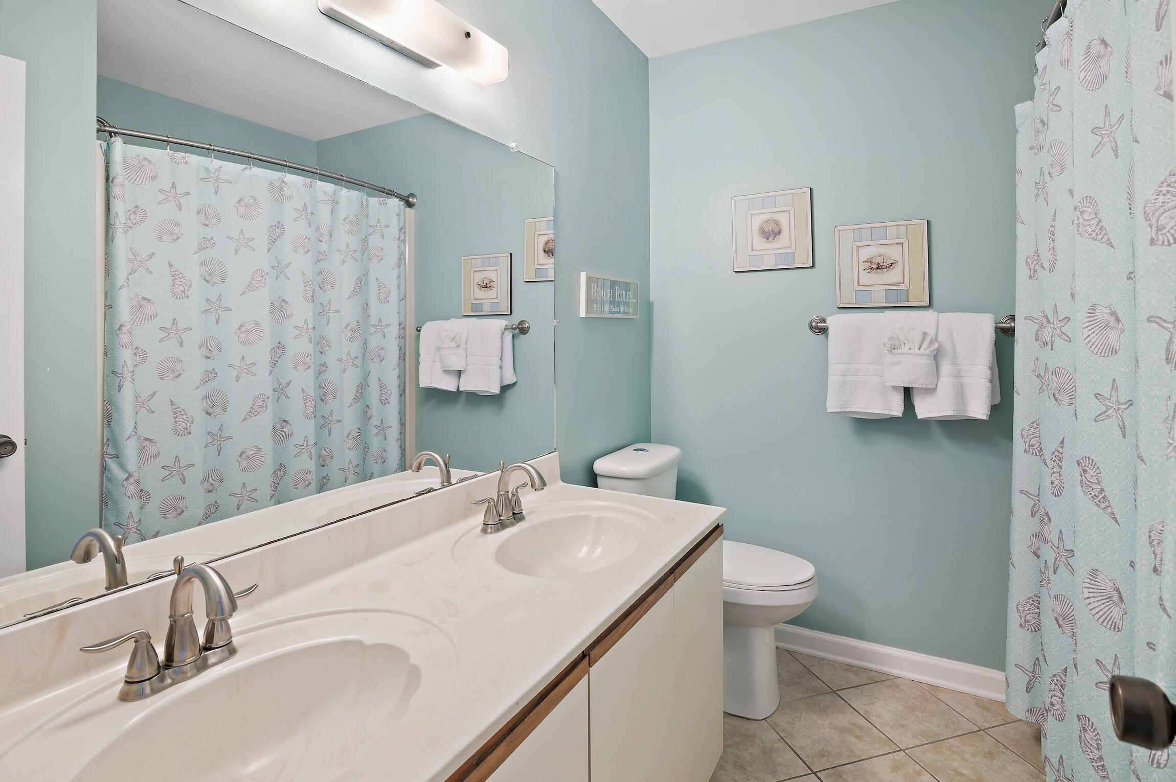 23011 Front Beach Road, Unit 24 Panama City Beach, FL 32413 - Photo 16 of 23 a bathroom with a sink toilet and shower