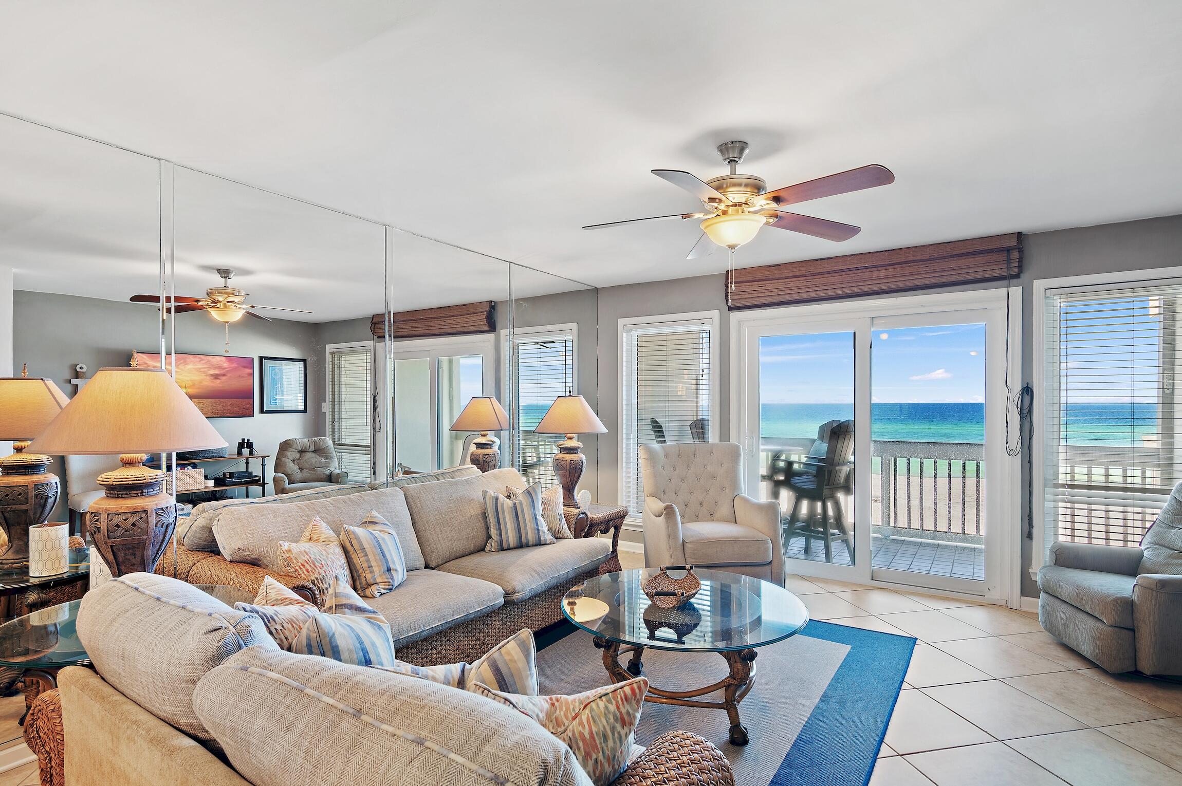 23011 Front Beach Road, Unit 24 Panama City Beach, FL 32413 - Photo 3 of 23 a living room with furniture and a chandelier