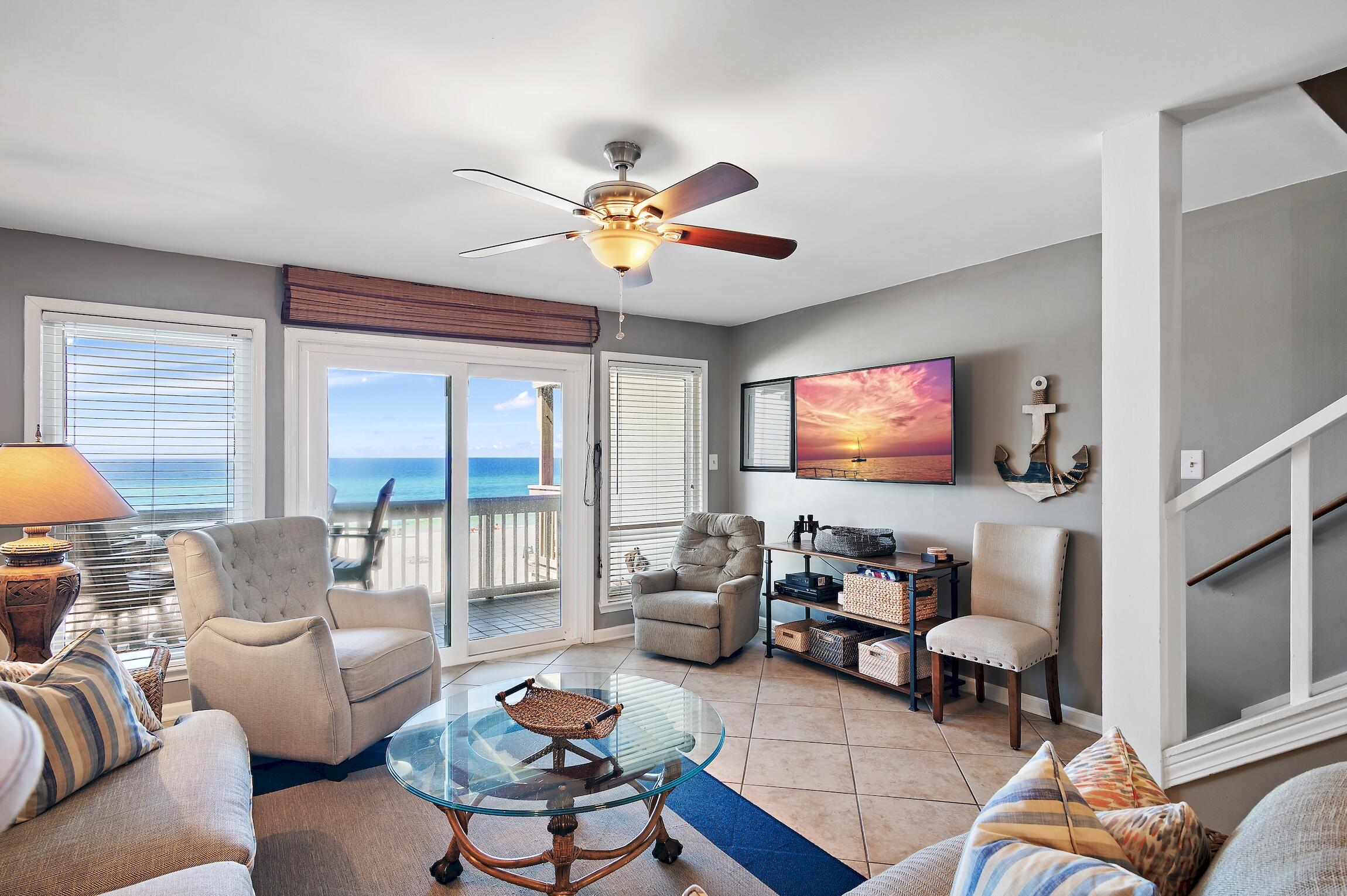 23011 Front Beach Road, Unit 24 Panama City Beach, FL 32413 - Photo 6 of 23 a living room with furniture and a flat screen tv
