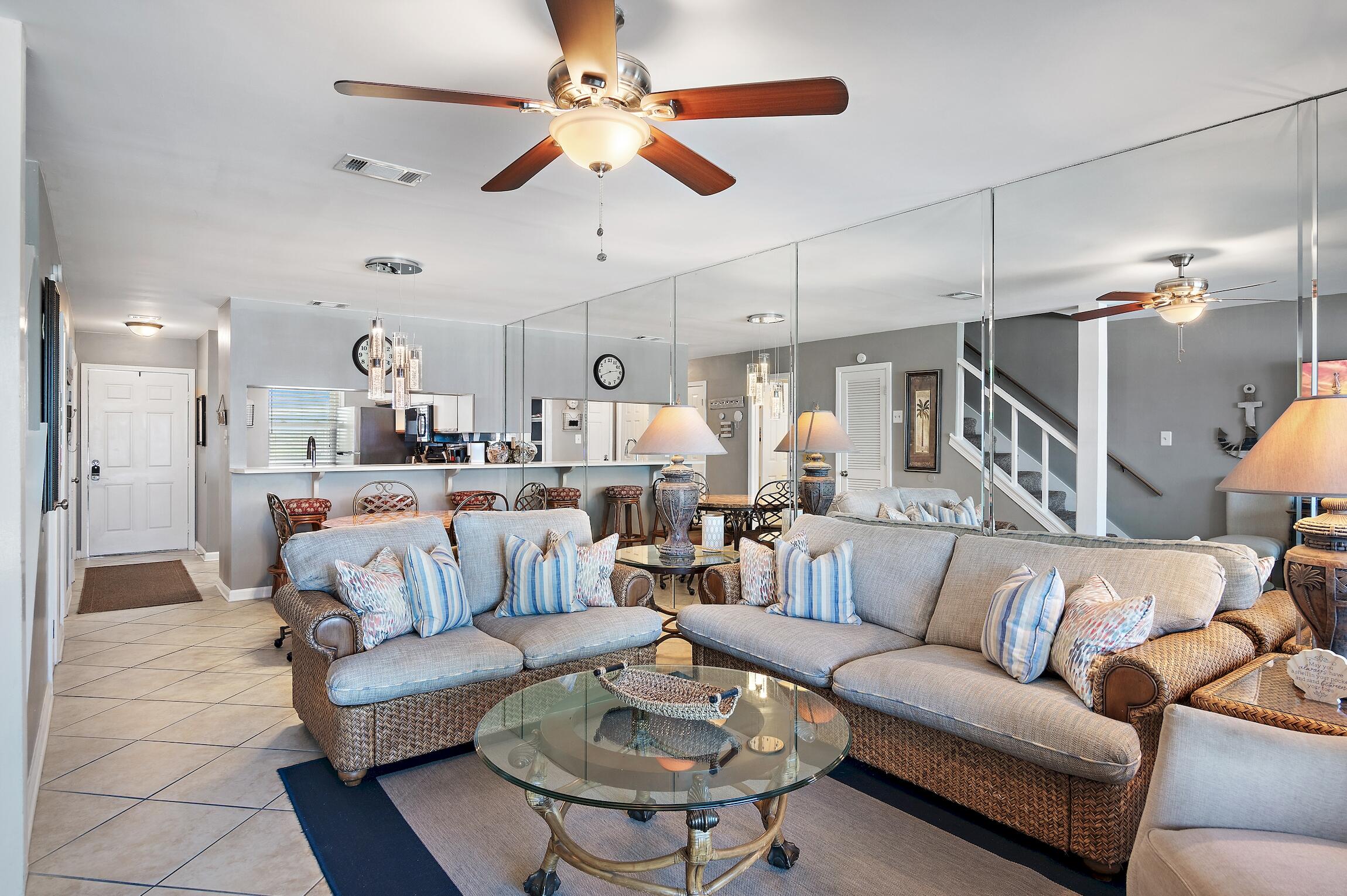 23011 Front Beach Road, Unit 24 Panama City Beach, FL 32413 - Photo 7 of 23 a living room with furniture kitchen view and a chandelier