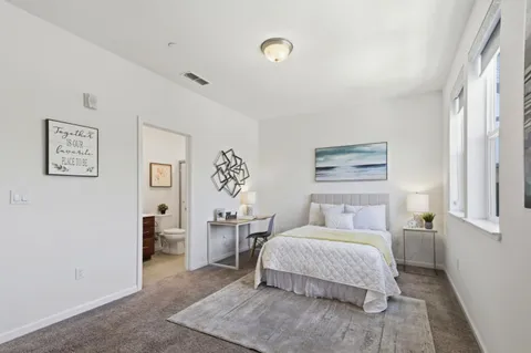 a bedroom with a bed and a night stand