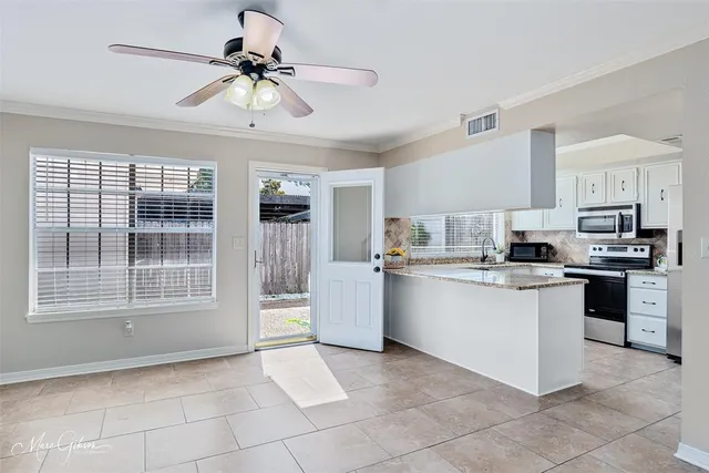 a kitchen with a refrigerator and a stove top oven
