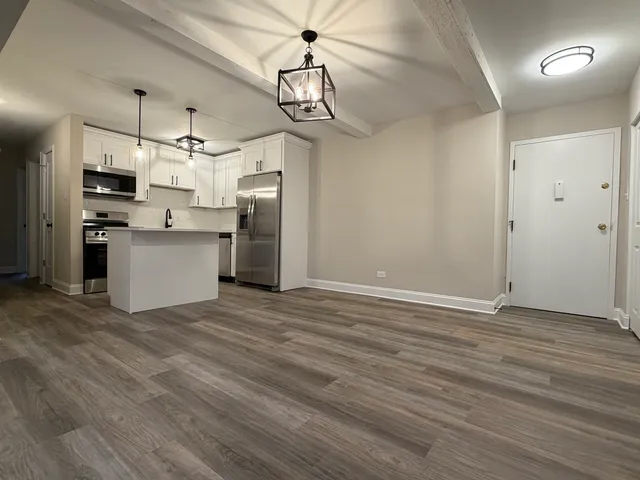 a view of a kitchen with a sink stainless steel appliances and cabinets