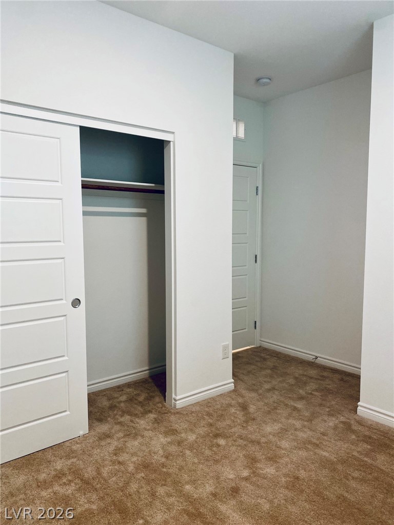 4457 Sawyer Ridge Street Las Vegas, NV 89147 - Photo 3 of 32 This cozy bedroom offers a soft carpeted floor and ample closet space, ready for personalization.