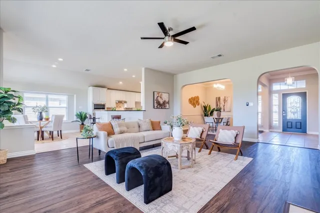 a living room with furniture and a wooden floor