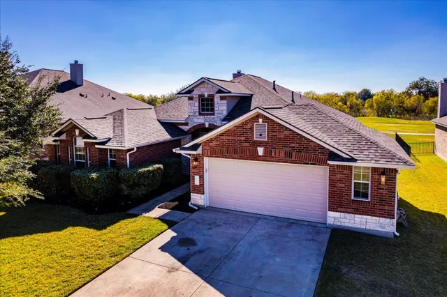 an aerial view of residential houses with outdoor space
