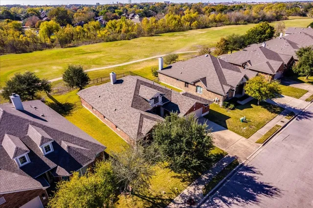 an aerial view of residential houses with outdoor space