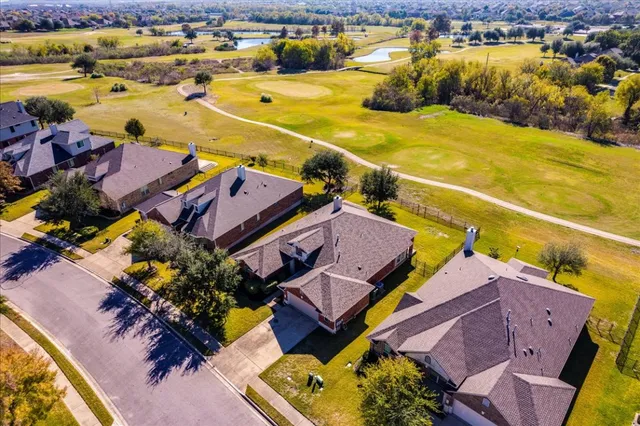an aerial view of a house with a yard