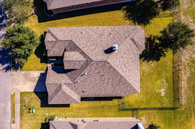 a view of a hallway with wooden floor and a livingroom with furniture
