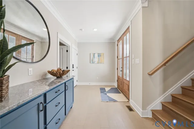 a spacious bathroom with a granite countertop double vanity and a mirror