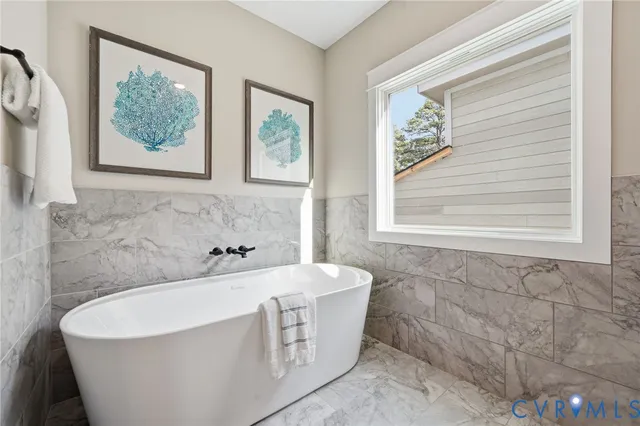 a bathroom with a bathtub and a window