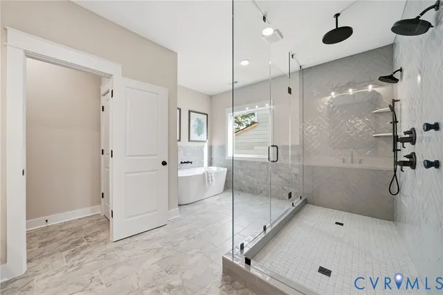 a bathroom with a tub shower vanity and sink
