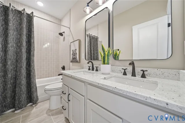 a bathroom with a double vanity sink mirror and toilet