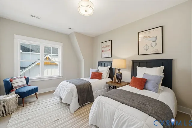 a bedroom with two beds and a couch