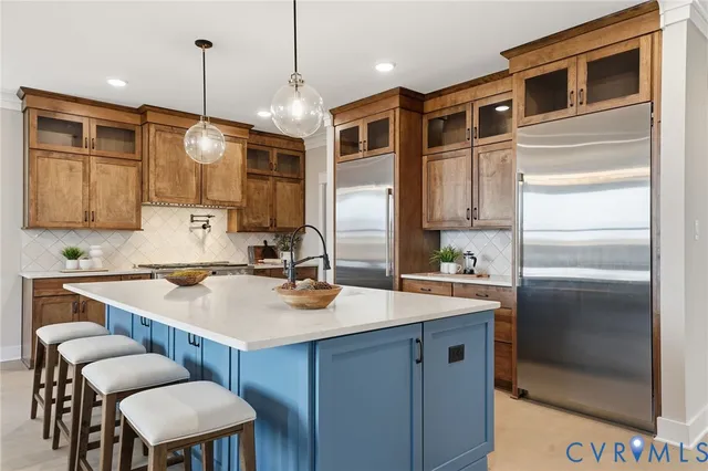 a kitchen with a sink refrigerator and microwave