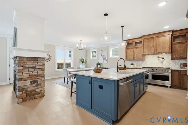 a kitchen with stainless steel appliances granite countertop a sink stove and cabinets