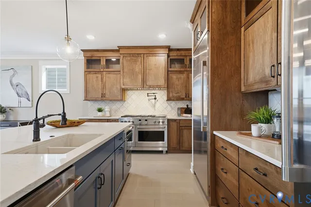 a kitchen with kitchen island granite countertop a sink stainless steel appliances and cabinets
