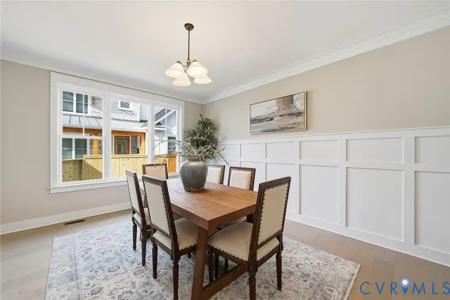 a view of a dining room with furniture and chandelier