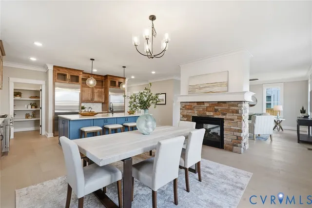 a view of a dining room with furniture wooden floor and a fireplace