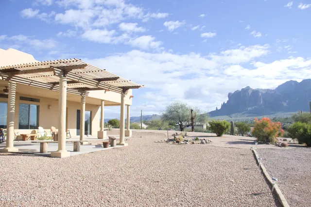 a bathroom with a granite countertop shower a sink and a mirror