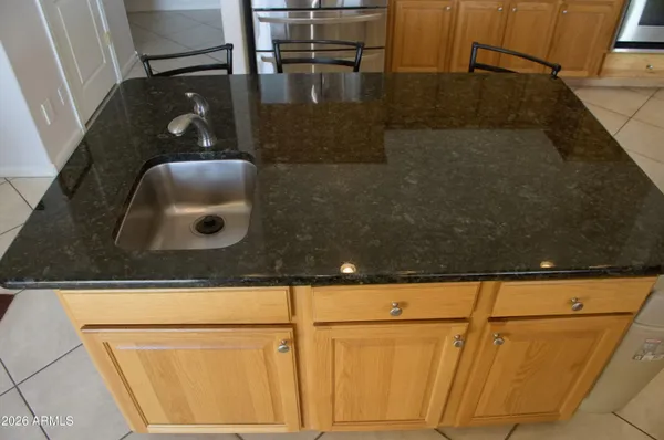 a living room with furniture and two windows