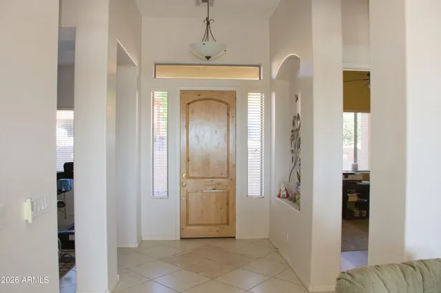 a kitchen with stainless steel appliances granite countertop a refrigerator a stove and a sink