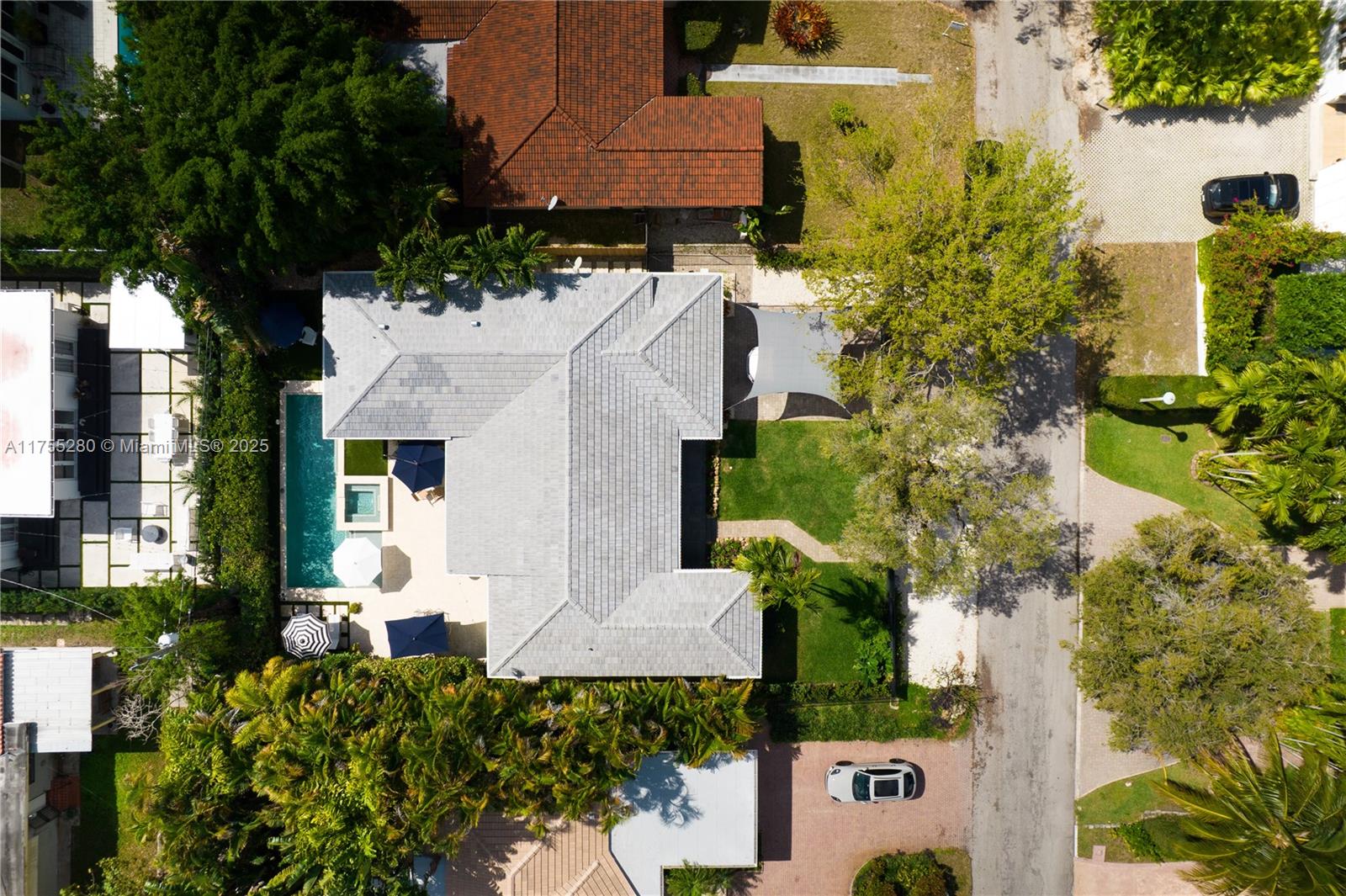 an aerial view of a house with a yard and garden