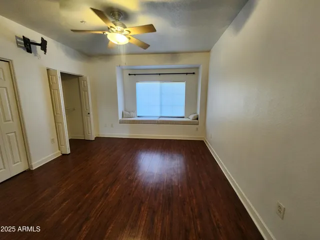 wooden floor in an empty room with a window