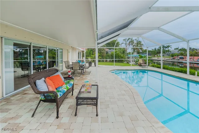 a swimming pool with outdoor seating and yard