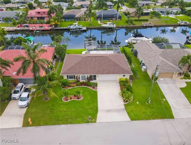 an aerial view of residential houses with outdoor space and swimming pool