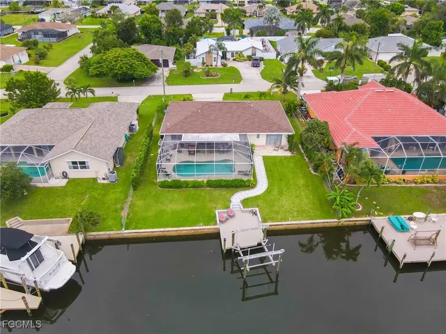 an aerial view of a house with a garden and lake view