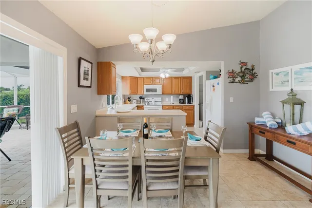 a view of a dining room with furniture and chandelier