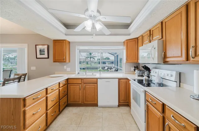 a kitchen with stainless steel appliances granite countertop a sink dishwasher stove and refrigerator