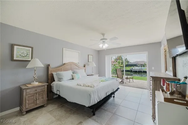 a bedroom with furniture and a large window
