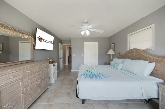 a spacious bedroom with a bed and a chandelier