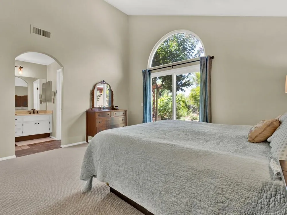 1591 Madrid Drive Vista, CA 92081 - Photo 12 of 40 a bedroom with a bed and a large window