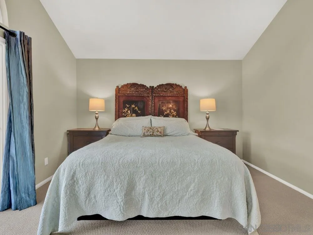 1591 Madrid Drive Vista, CA 92081 - Photo 13 of 40 a bedroom with a bed and mirror