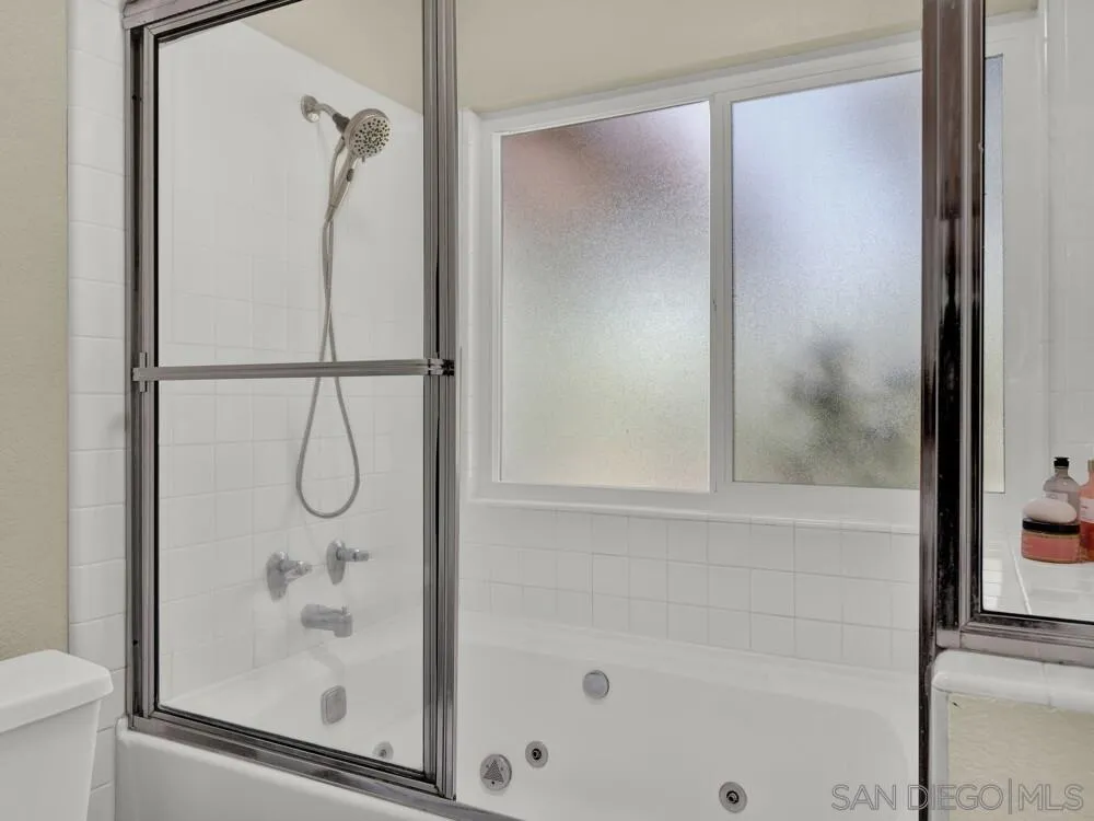 1591 Madrid Drive Vista, CA 92081 - Photo 14 of 40 a bathroom with a glass shower door