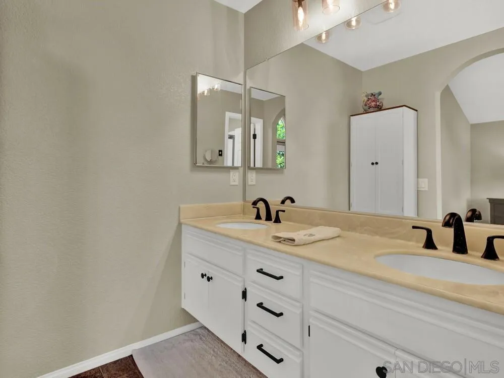1591 Madrid Drive Vista, CA 92081 - Photo 15 of 40 a bathroom with a granite countertop sink and a mirror