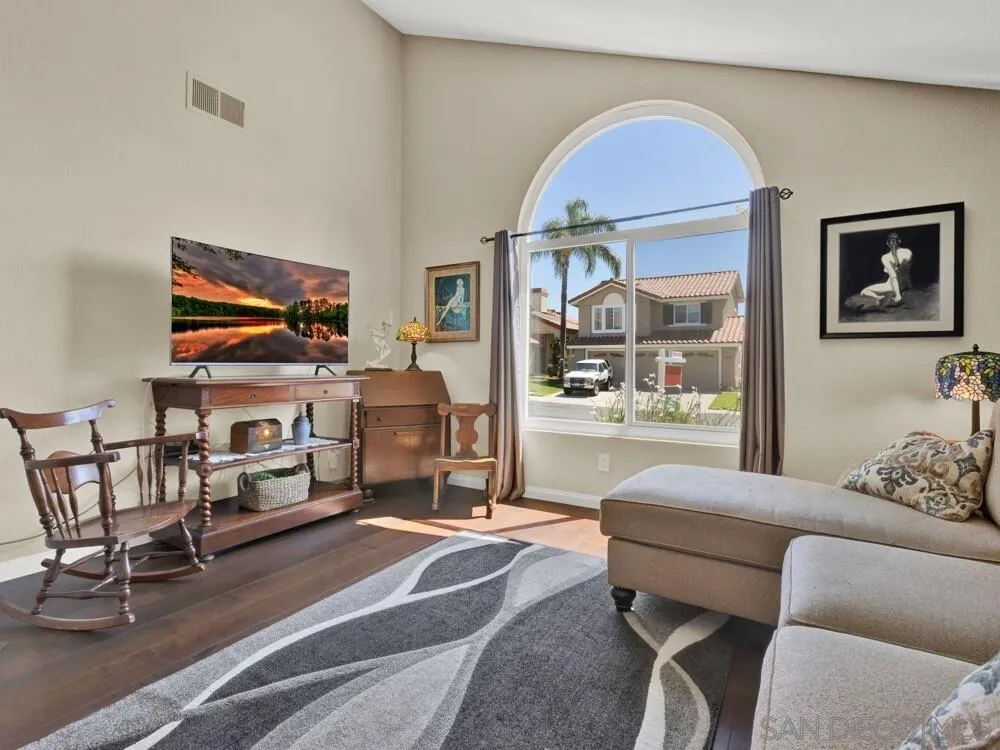 1591 Madrid Drive Vista, CA 92081 - Photo 2 of 40 a living room with furniture a piano and a flat screen tv