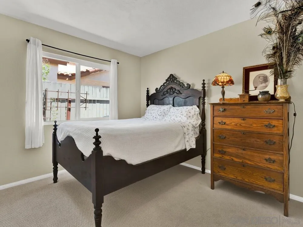 1591 Madrid Drive Vista, CA 92081 - Photo 22 of 40 a bedroom with a bed and a window