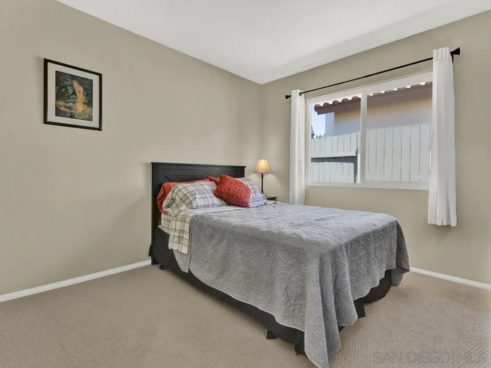 1591 Madrid Drive Vista, CA 92081 - Photo 23 of 40 a bedroom with a bed and window