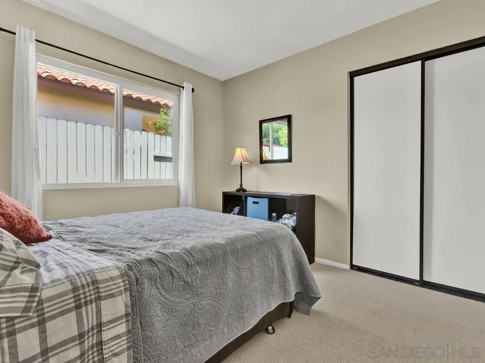 1591 Madrid Drive Vista, CA 92081 - Photo 24 of 40 a bedroom with a bed and a window