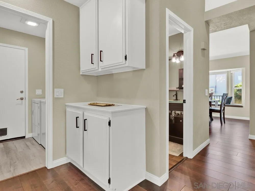 1591 Madrid Drive Vista, CA 92081 - Photo 26 of 40 an entryway space with wooden floor and cabinets