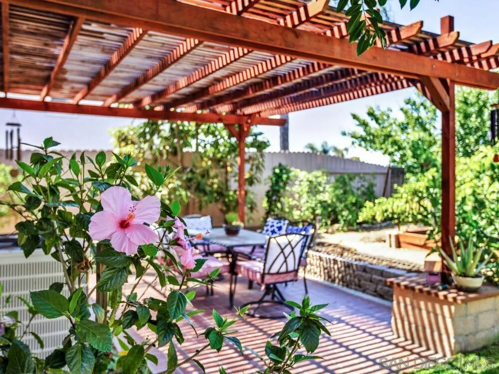1591 Madrid Drive Vista, CA 92081 - Photo 32 of 40 a patio with table and chairs and potted plants