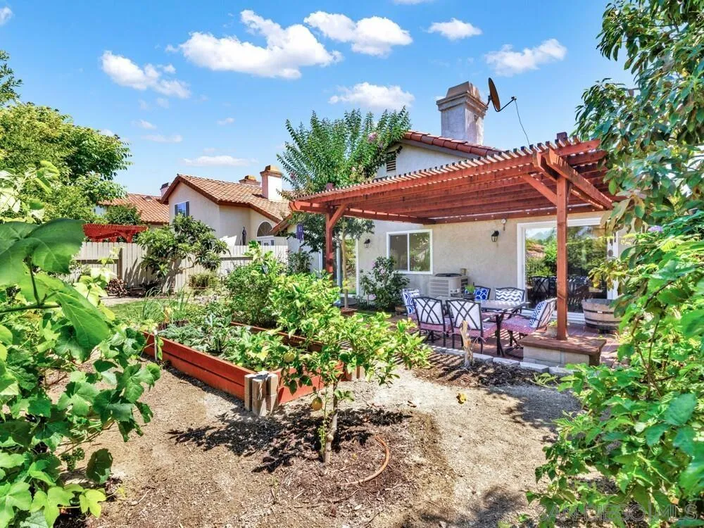 1591 Madrid Drive Vista, CA 92081 - Photo 36 of 40 a view of a patio with table and chairs under an umbrella