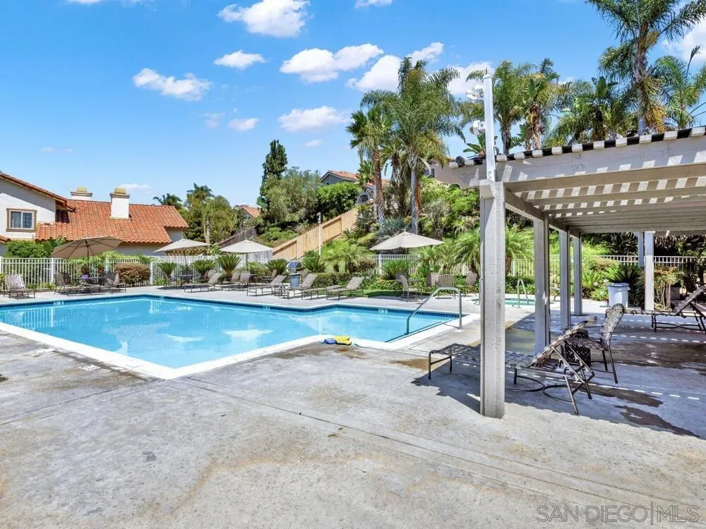 1591 Madrid Drive Vista, CA 92081 - Photo 39 of 40 a view of a swimming pool with lawn chairs and a fire pit