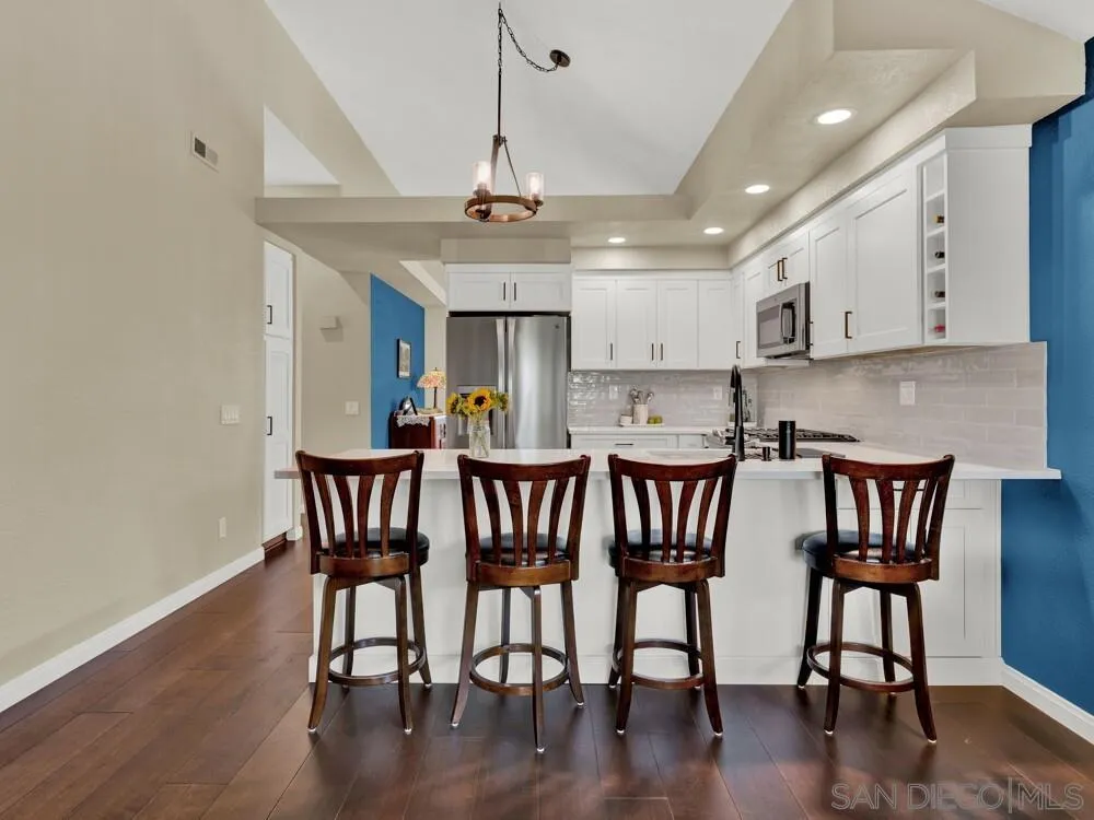 1591 Madrid Drive Vista, CA 92081 - Photo 10 of 40 a view of kitchen and dining room with wooden floor