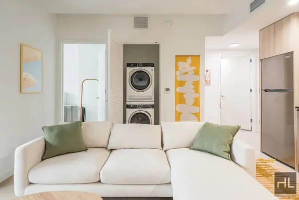 a living room with a couch and washer