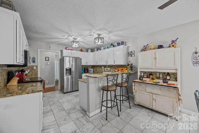 a bedroom with a bed furniture and a flat tv screen